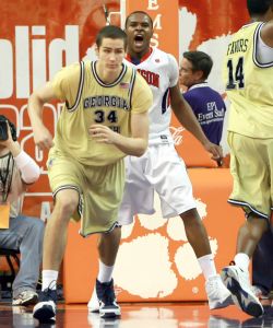 Clemson's Trevor Booker, back center, yells after making a dunk while Georgia Tech's Brad Sheehan (24) runs up court during the first half of an NCAA college basketball game on Tuesday, March 2, 2010 at Littlejohn Coliseum in Clemson, S.C. (AP Photo/Anderson Independent-Mail, Mark Crammer)
