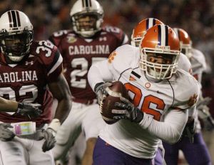 Clemson's La Donte Harris (26) runs the ball in for a touchdown after a blocked punt during the first quarter of a football game against South Carolina on Saturday, Nov. 24, 2007, in Columbia, S.C. (AP Photo/Mary Ann Chastain)
