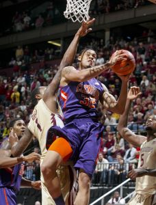 Clemson guard K.J. McDaniels (32) is fouled by Florida State's Xavier Gibson (1) as he goes for a layup in the second half. (AP Photo/Phil Sears)