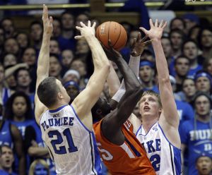 Clemson's Jerai Grant gets up a shot between a pair of Duke defenders during the first half an NCAA college basketball game in Durham, N.C., Wednesday, March 2, 2011. (AP Photo/Gerry Broome)