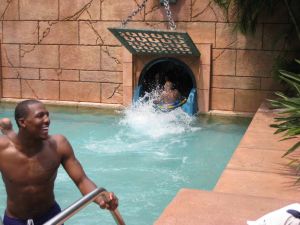 Sam Perry jokes with teammates as freshman Jonah Baize gets spit out of the Serpent Slide.