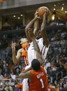 Miami forward Brian Asbury goes up for a shot against David Porter and K.C.Rivers. (AP Photo/Wilfredo Lee)