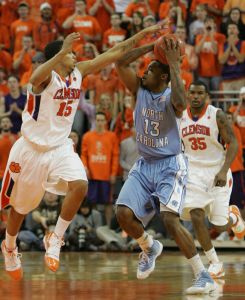 North Carolina's Will Graves (13) tries to pass the ball as Clemson's David Potter (15) tries to knock it loose during the first half of an NCAA college basketball game Wednesday, Jan. 13, 2010, in Clemson, S.C. Looking on is Clemson's Trevor Booker (35). (AP Photo/Mary Ann Chastain)