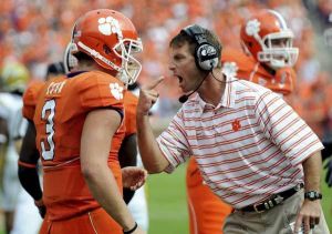 Clemson's interim head coach Dabo Swinney, right, and Willy Korn (3) discuss the previous play during the first half.