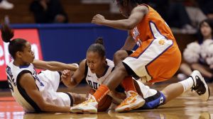 Duke's Jasmine Thomas, left, and Shay Selby, center, fall to the floor with Clemson's Kelia Shelton, right, during the second half. (AP Photo/Gerry Broome)
