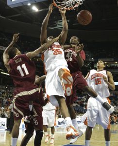 Clemson's Trevor Booker (35) dunks between Florida State defenders Jerel Allen (11), Uche Echefu (41) and Clemson's David Potter (15) during the first half of a first round game of the Men's Atlantic Coast Conference basketball tournament in Tampa, Fla., Thursday, March 8, 2007. (AP Photo/David J. Phillip)