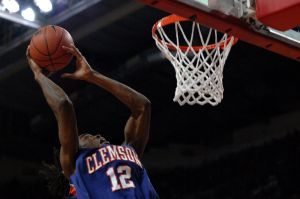 Raymond Sykes vaults above the rim for a rebound (Photo by Zach Hanby)