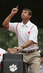 Clemson's head coach Dabo Swinney touches Howards Rock as he arrives. (AP)
