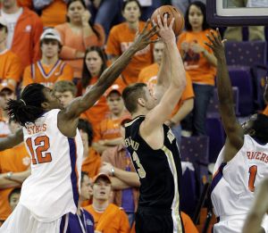 Raymond Sykes, left, and K.C. Rivers, right, try to block the shot of Wake Forest's Chas McFarland during the first half of the baketball game in Clemson, S.C., Tuesday, Jan. 22, 2007. (AP Photo/Patrick Collard)