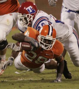 C.J. Spiller dives for extra yardage as Louisiana Tech's Sandy Ray Collins (20) tries to stop in the first half. (AP Photo/Mary Ann Chastain)