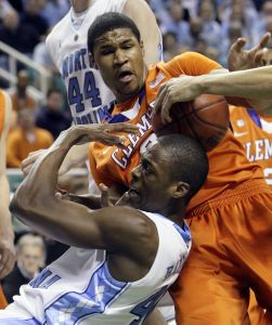 Clemson's Devin Booker, top, tries to wrestle the ball from North Carolina's Harrison Barnes, bottom, during the first half of an NCAA college basketball game at the Atlantic Coast Conference tournament in Greensboro, N.C., Saturday, March 12, 2011. (AP Photo/Gerry Broome)