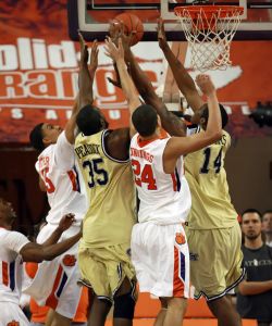 Clemson's David Potter, left, and Milton Jennings (24) battle Georgia Tech's Zachery Peacock (35) and Derrick Favors, right, for a rebound during the first half of an NCAA college basketball game on Tuesday, March 2, 2010 at Littlejohn Coliseum in Clemson, S.C. (AP Photo/Anderson Independent-Mail, Mark Crammer)