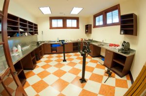 Wide angle photos of the interior rooms of the Penley Golf Facility. Club repair room