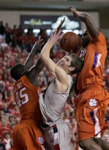 Liberty forward Kyle Ohman, center, tries for a shot as Clemson defenders, Jerai Grant (45) and Trevor Booker, right, attempt a block during the first half of their college basketball game at the Vines Center in Lynchburg, Va., Tuesday, Nov. 17, 2009. (AP Photo/Steve Helber)
