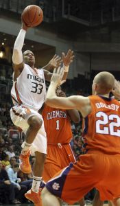 Miami's Jack McClinton shoots and scores as Clemson's K.C. Rivers and Terrence Oglesby defend during first half. (AP Photo/Jeffrey M. Boan)