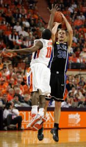 Duke's Jon Scheyer (30) shoot a three pointer as Clemson's Andre Young (11) tries to block the shot during the first half of an NCAA college basketball game Saturday, Jan. 23,2010, at Littlejohn Coliseum in Clemson, S.C. (AP Photo/Mary Ann Chastain)