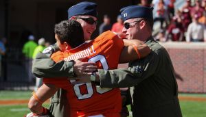 Daniel Rodriguez greeted U.S. Air Force Captains Michal Polidor and Justin Kulish during a special recognition ceremony following the third quarter of the game.