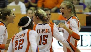 The Tigers celebrate following a point won in their match against Virginia.