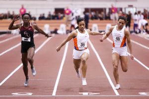 Dezerea Bryant, center, holds off teammate Stormy Kendrick at the line to claim the 60-meter dash on Saturday.