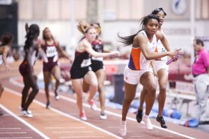 Marlena Wesh takes the baton from Keni Harrison and leads Clemson's 4x400 relay to a fourth straight ACC title in that event.