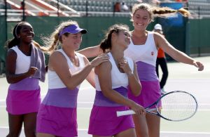 Beatrice Gumulya surrounded by teammates after her win.
