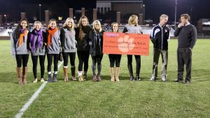 Head Coach Mike Noonan and members of the Clemson women?s soccer team presented a check to Red Card Cancer for donations raised by the men?s and women?s teams during the 2013 season.