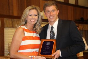 Academic Advisor Lindsey Ricketts presents the Senior GPA Award to Bobby Belair