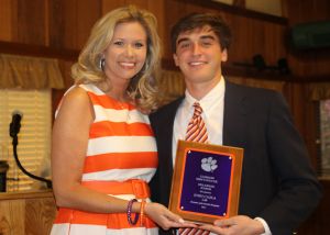 Academic Advisor Lindsey Ricketts presents the Junior GPA Award to John Cajka