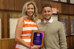 Junior Midfielder Paul Clowes presents the Service Award to Academic Advisor Lindsey Ricketts