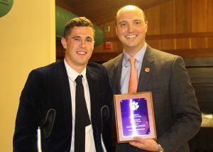 Assistant Director of IPTAY Major Gifts presents the Newcomer of the Year Award to Oliver Shannon